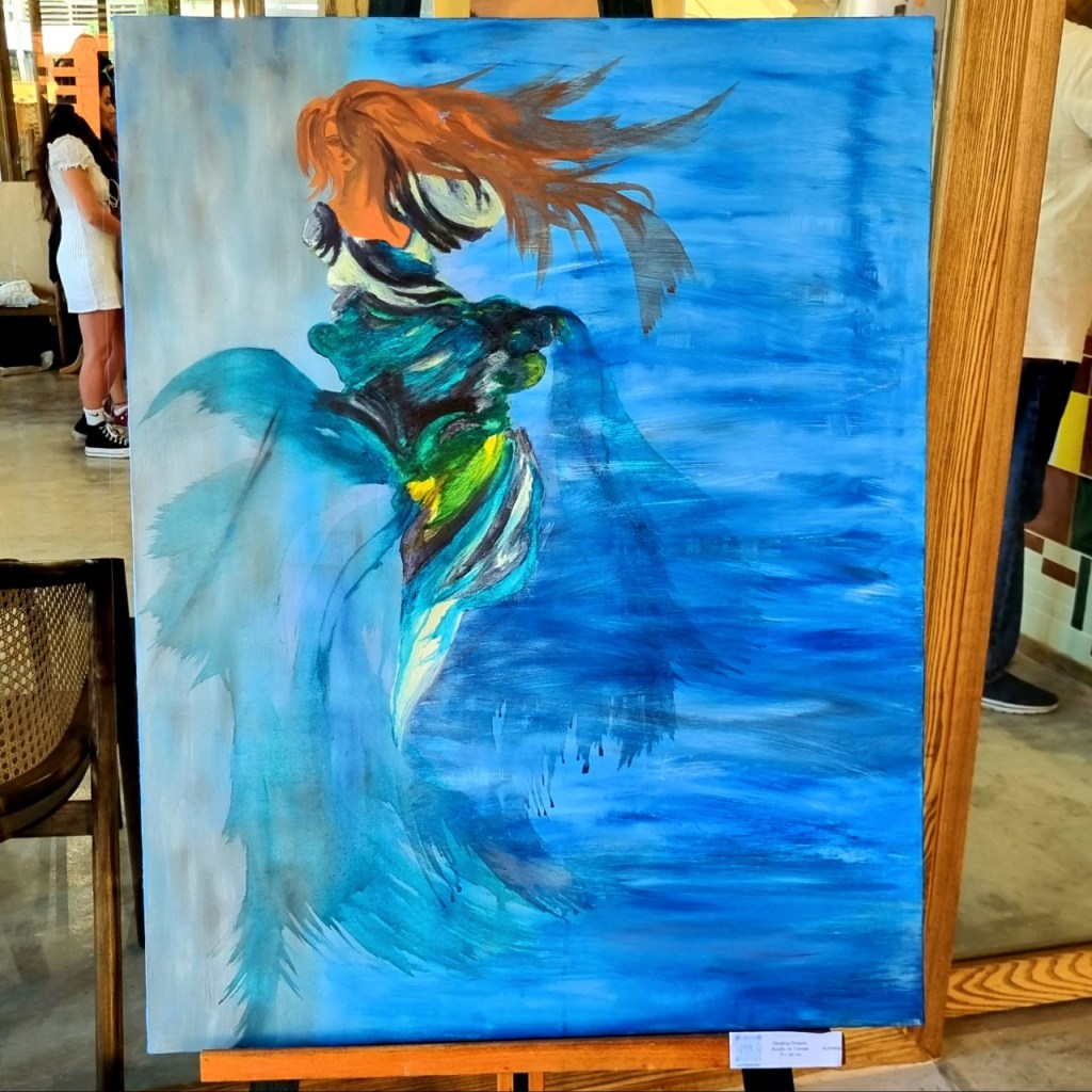 A canvas painting of a floating lady in the blue ocean. 