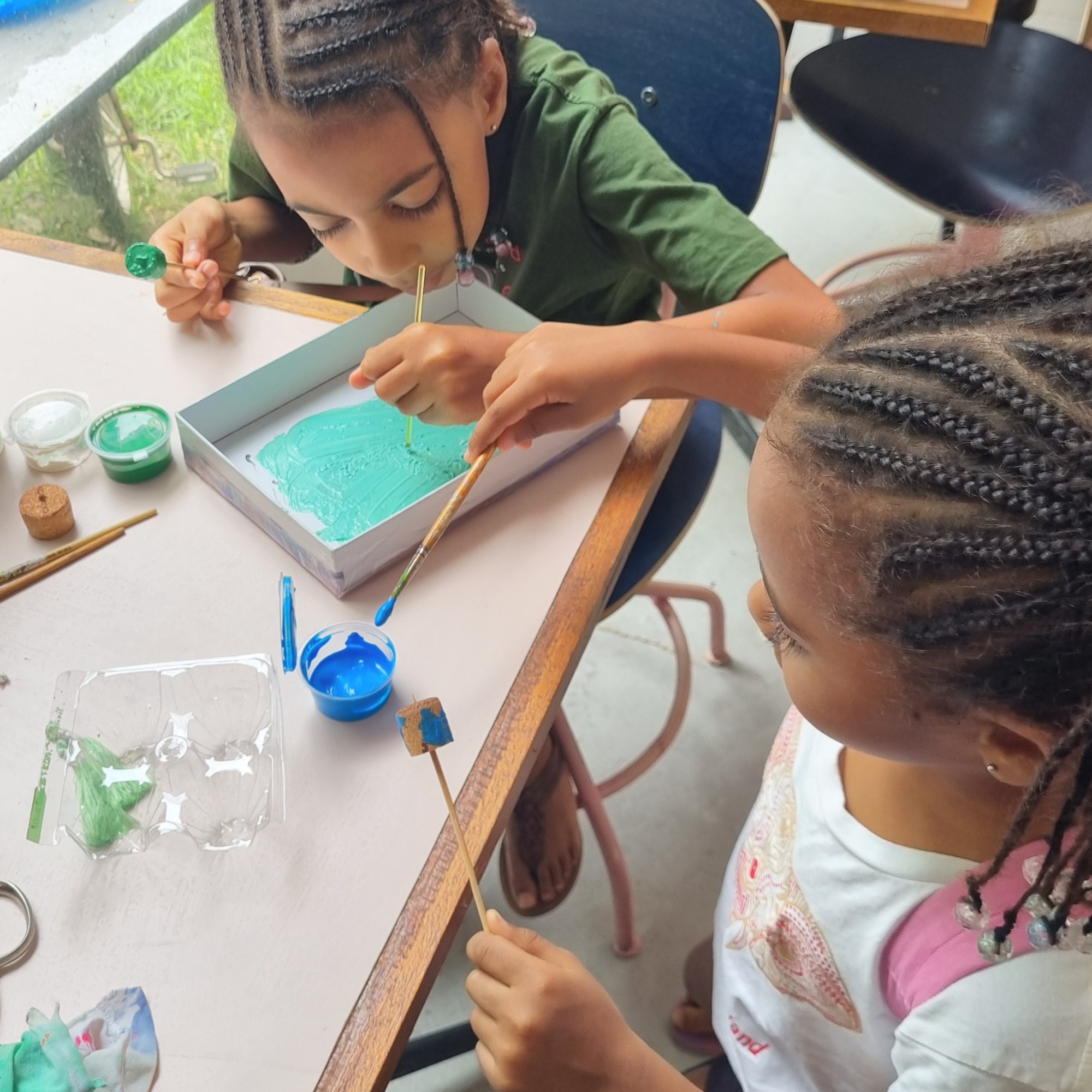 Kids painting and making their own earrings.